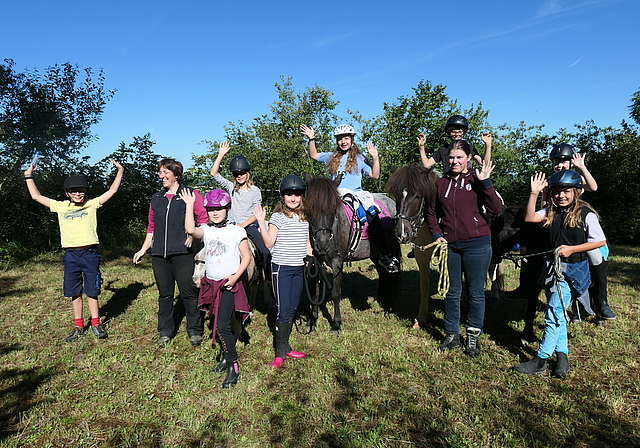 Auf dem Reitplatz freuen sich (v. l.) Ben, Leiterin Sibylle Müller, Anna Sofia, Doreen, Stella, Lynn, Lyam, Co-Leiterin Eileen, Duja, Alisha mit den Ponys und Islandpferden Vanilla, Rökkva, Skjoni und Maja. Foto: U. Handschin